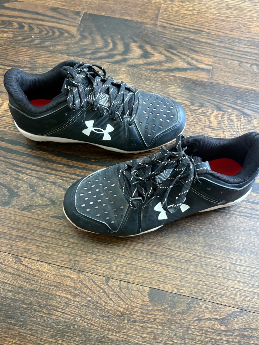 Under Armour Black and White Athletic cleats - youth 4